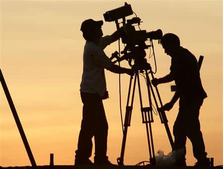 A Cuban television crew sets up their camera at Havana's sea front El Malecon